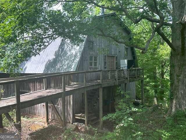 a balcony with wooden floor in front of house