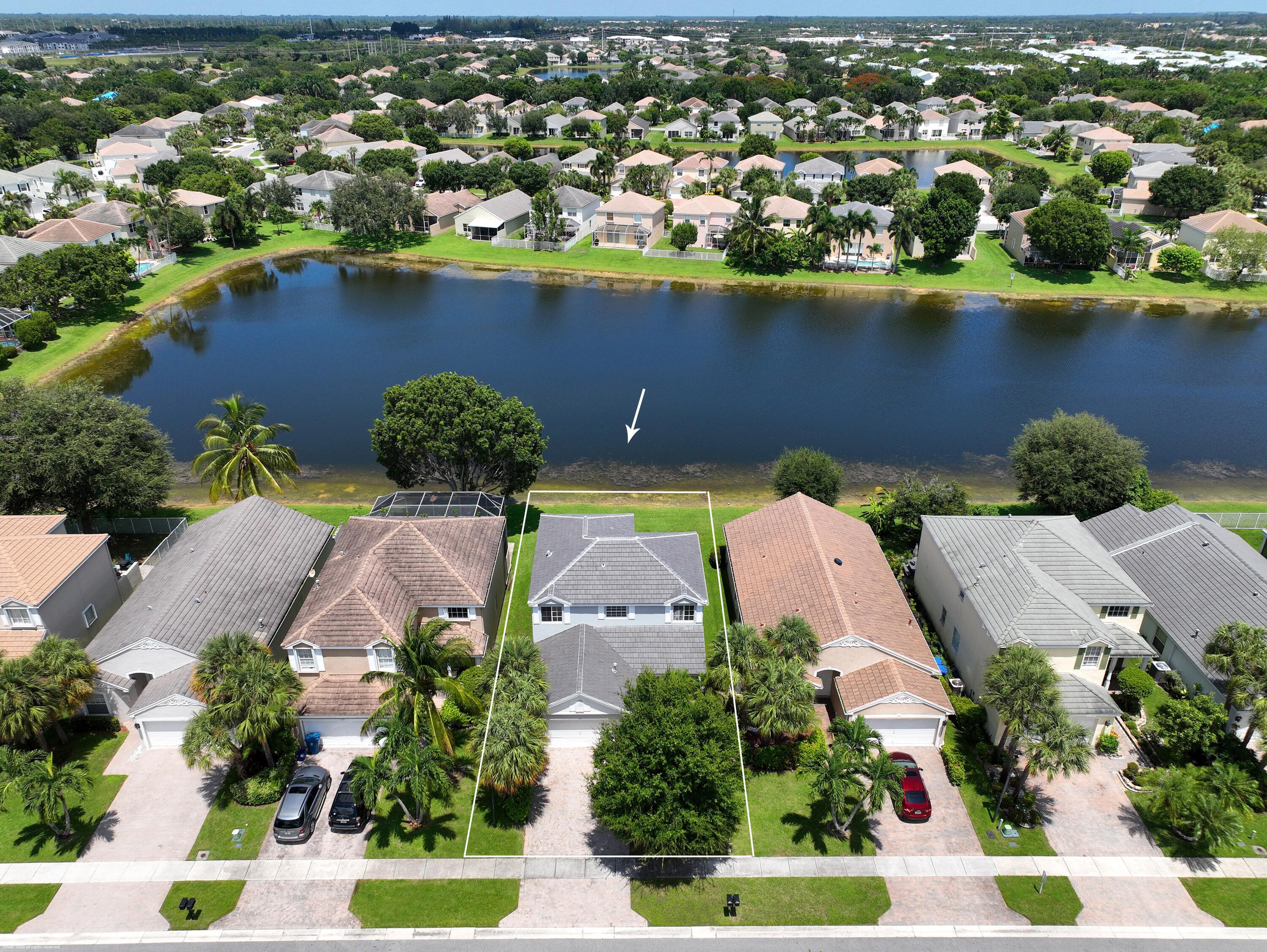 an aerial view of a house with a lake view