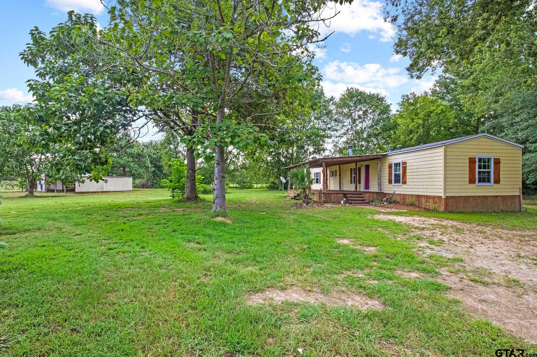 a view of a house with a backyard