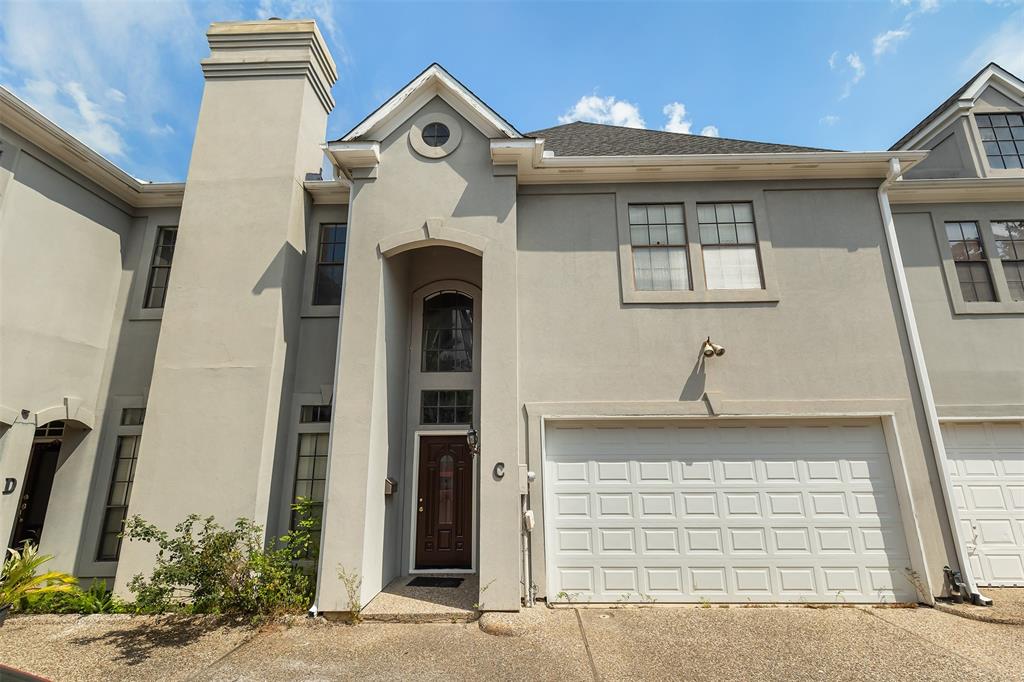 a front view of a house with garage