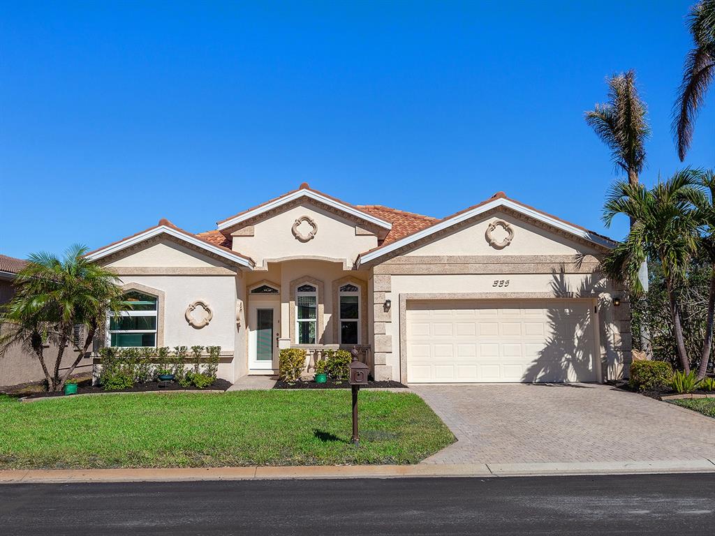 a front view of a house with a yard and garage