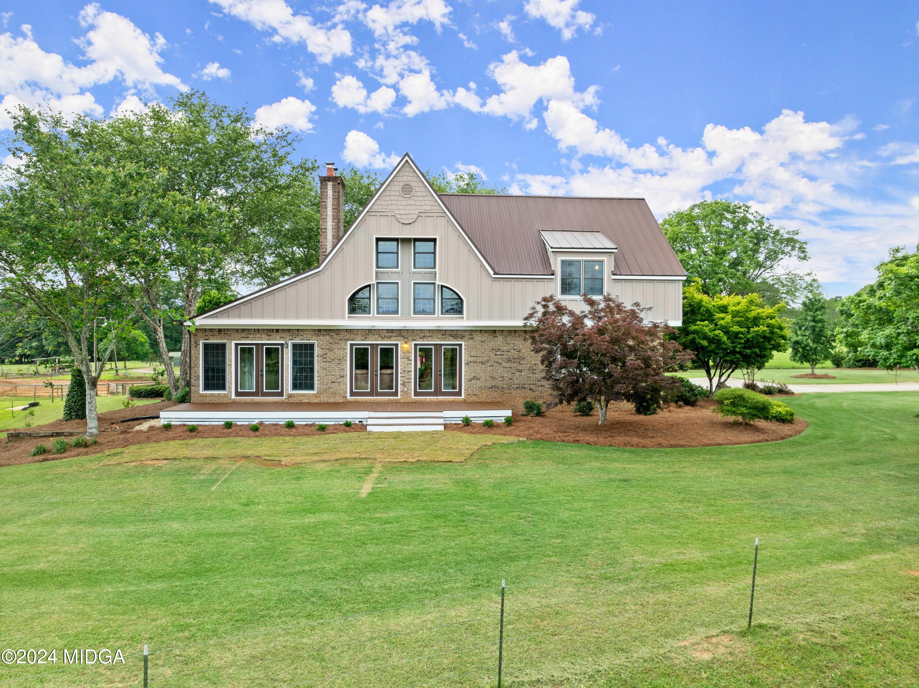 a front view of a house with a garden