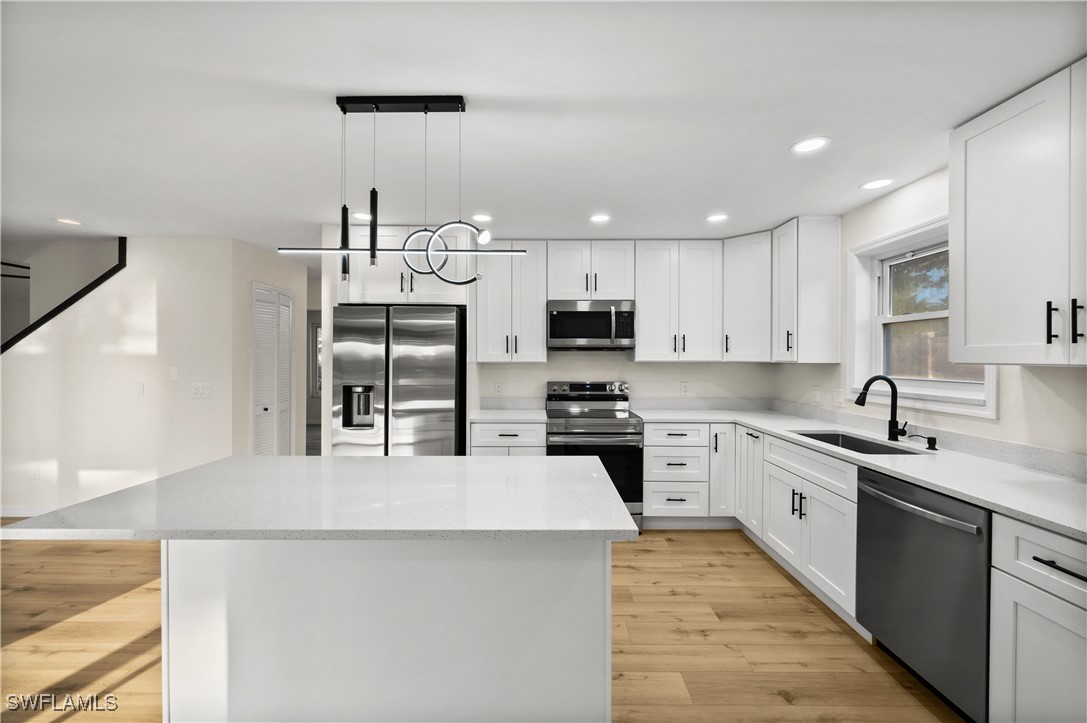 a kitchen with stainless steel appliances a sink stove and refrigerator