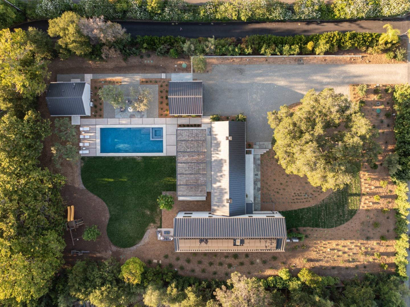 an aerial view of a house with a yard and lake view