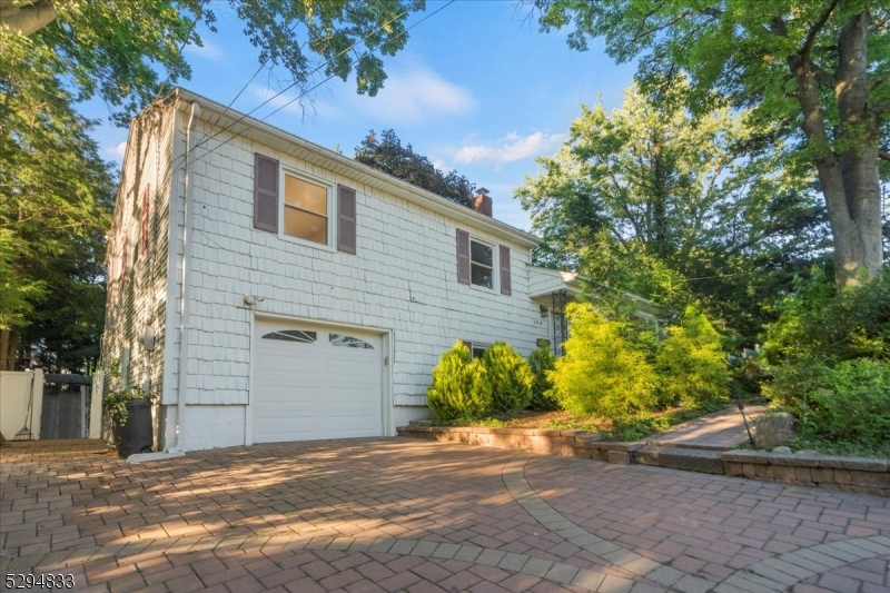 a view of a house with a yard and garage