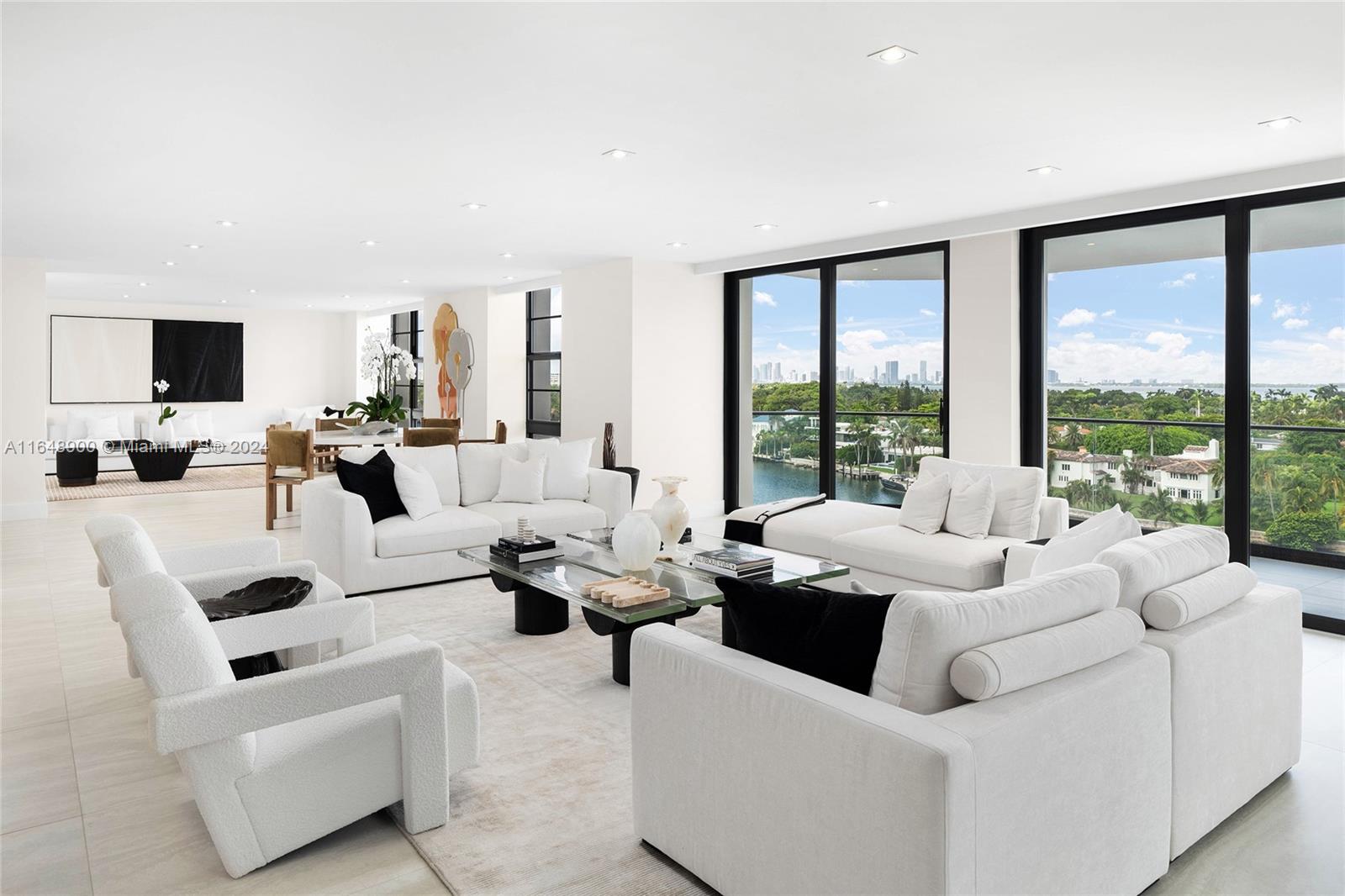 a living room with furniture and large windows