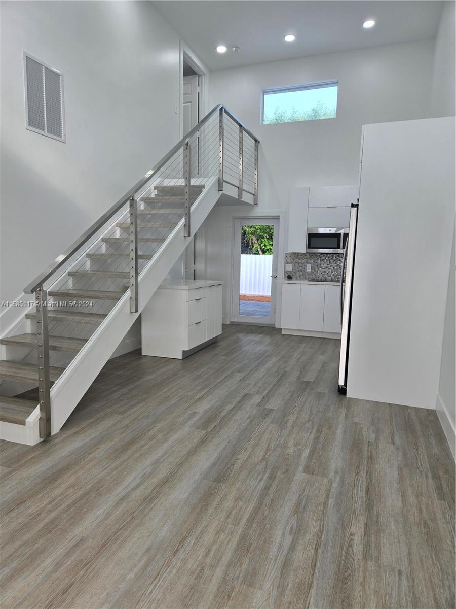 a view of entryway and hall with wooden floor