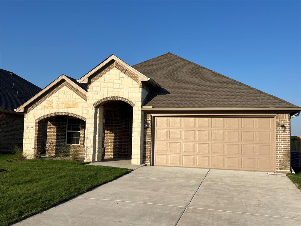 a view of a house with yard and garage