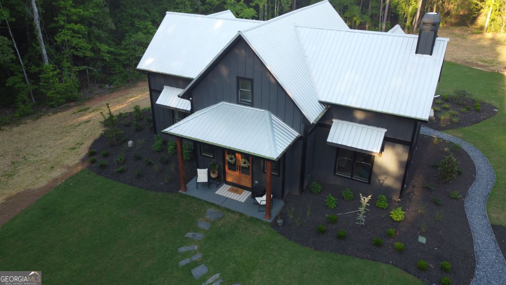 an aerial view of a house with garden space and street view