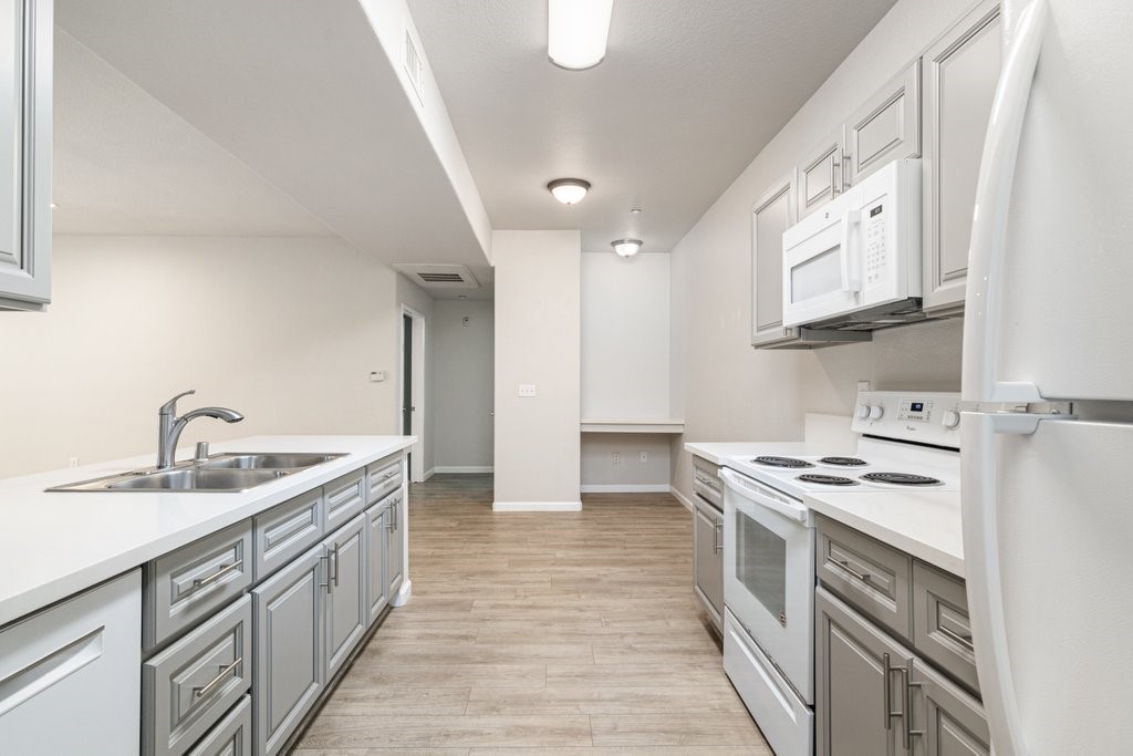 a kitchen with stainless steel appliances granite countertop a sink stove and cabinets