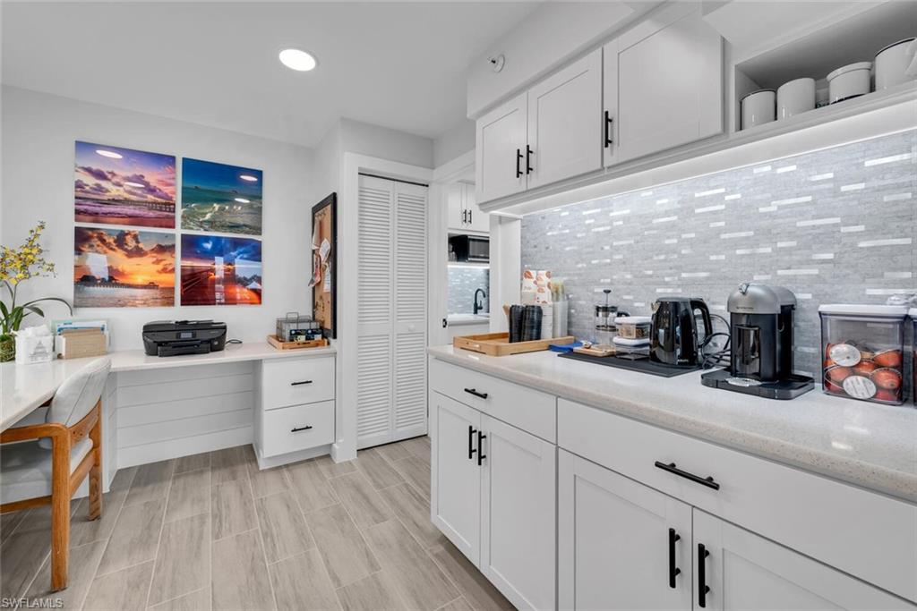 a kitchen with cabinets stainless steel appliances and a window