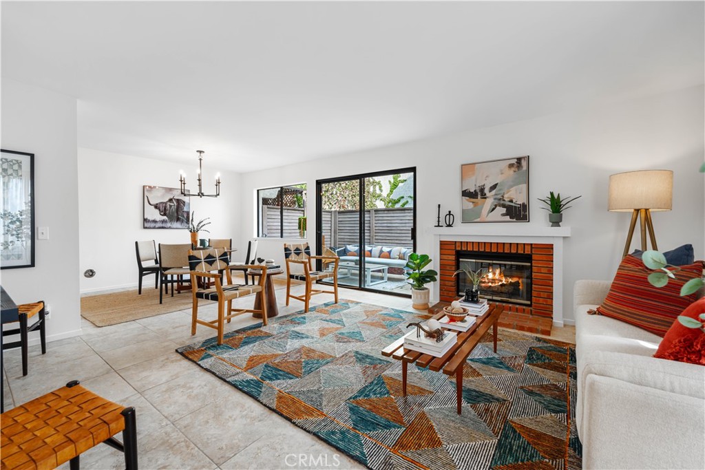 a living room with furniture a fireplace and a table