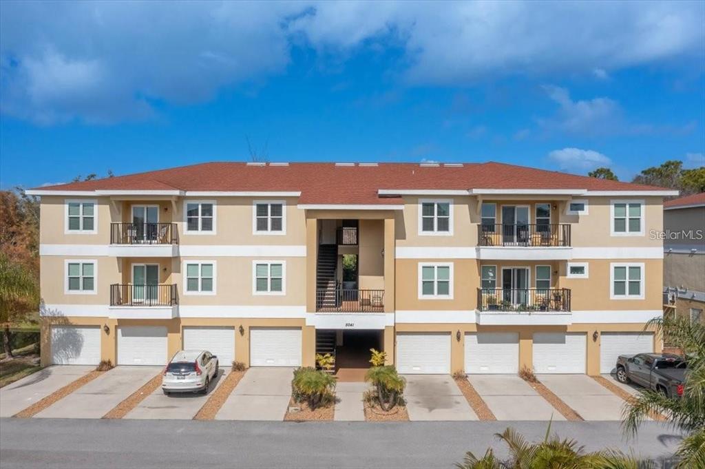 a front view of a residential apartment building with a yard