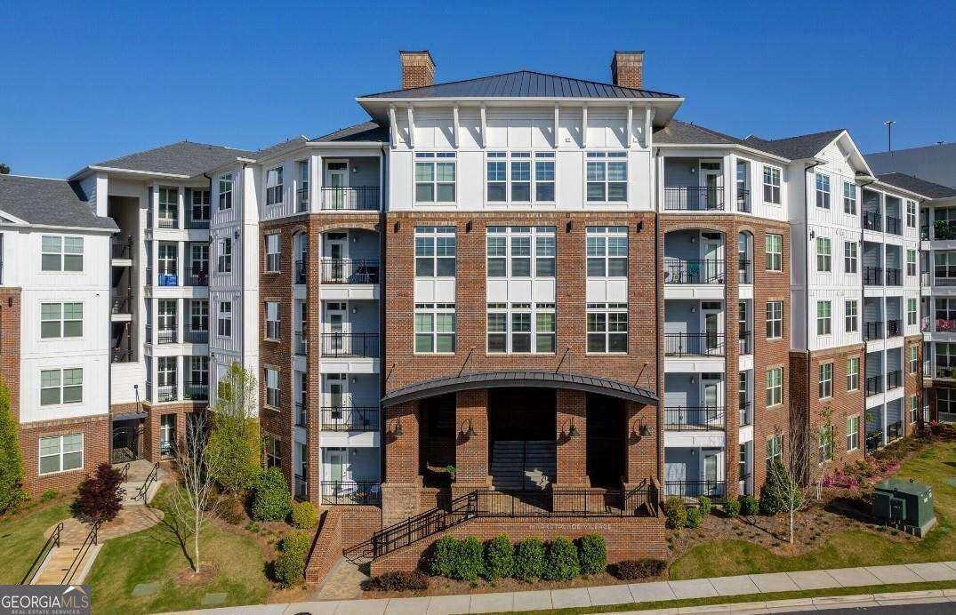 a front view of a residential apartment building with a yard