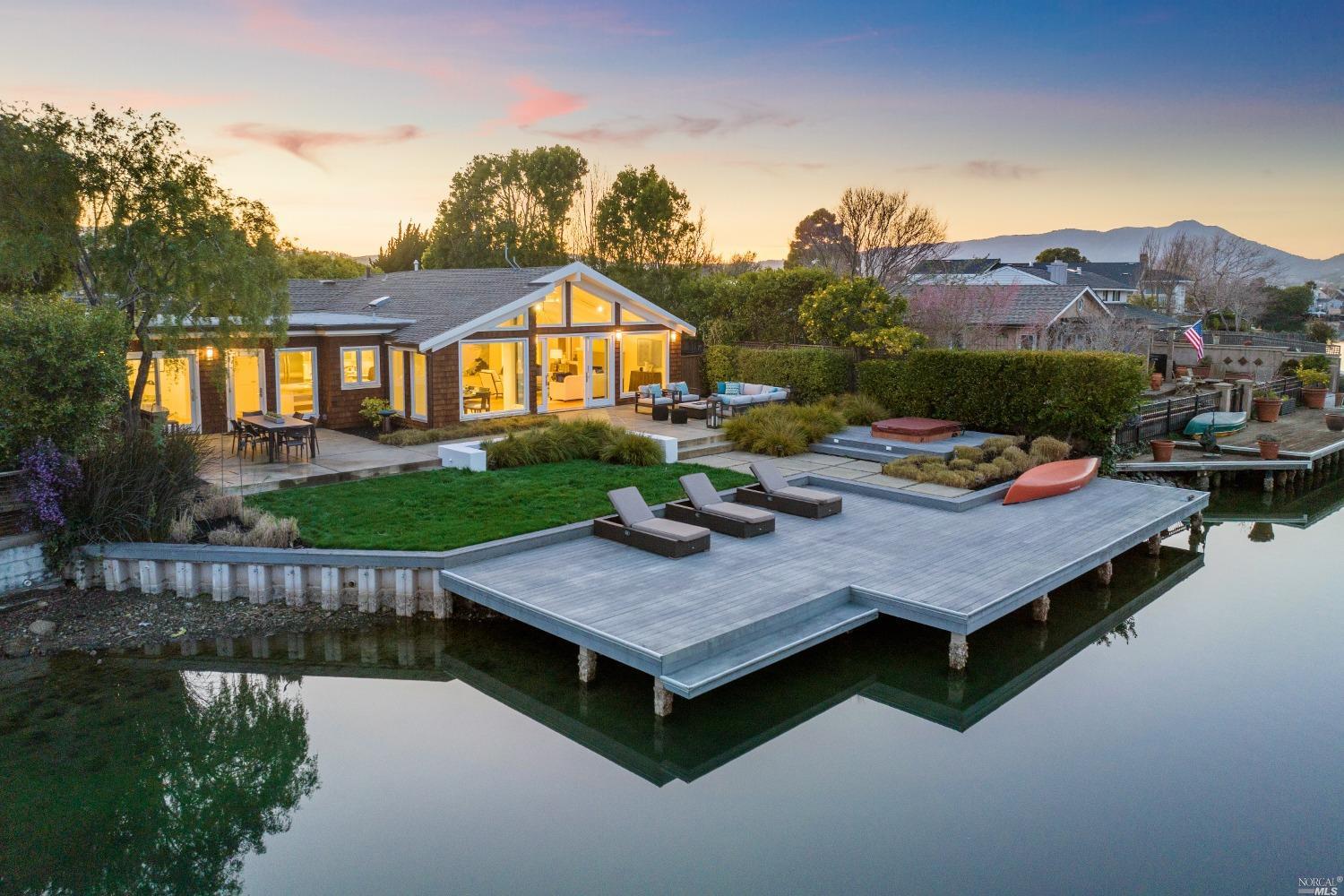 a view of a house with pool and chairs