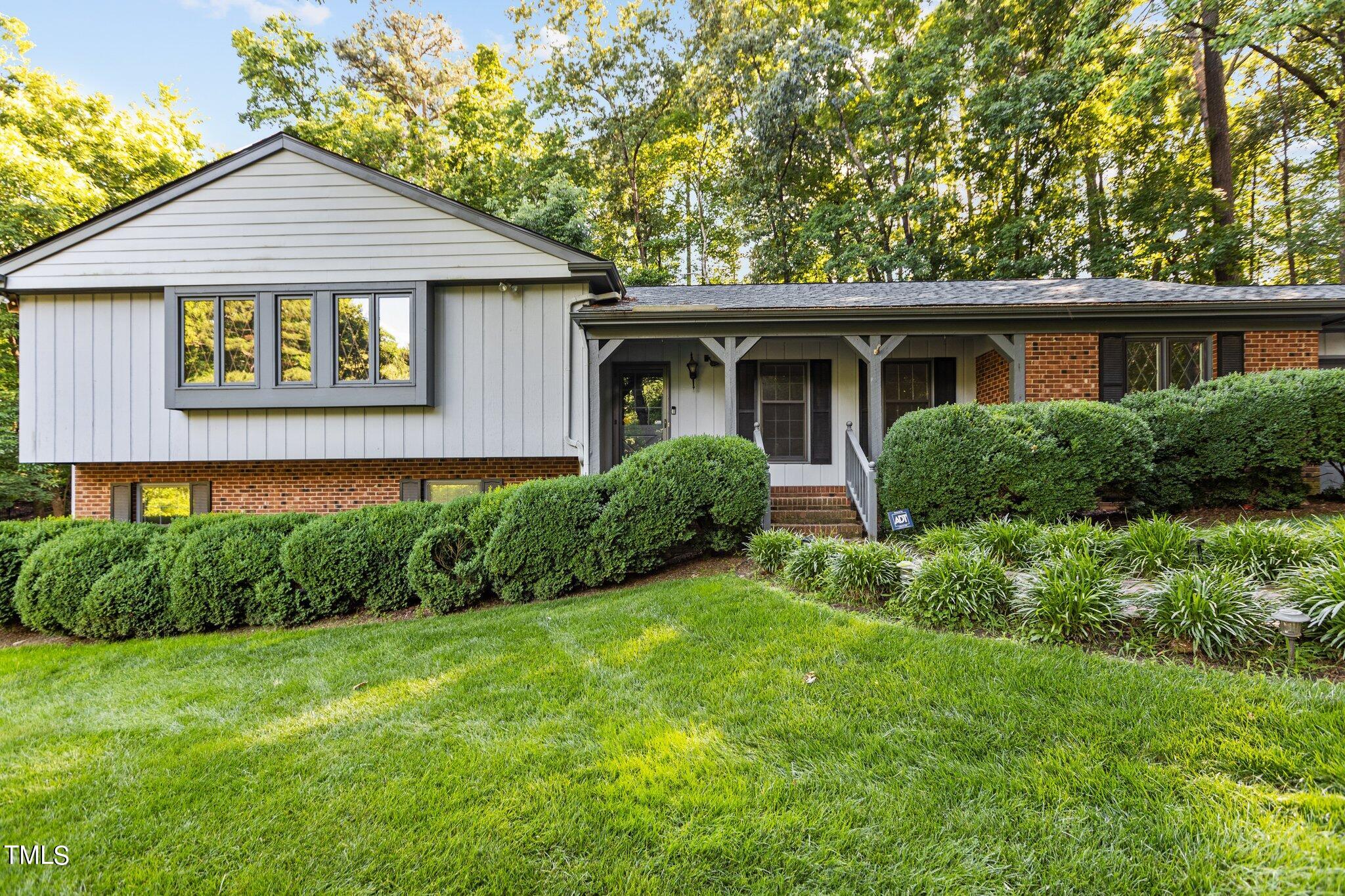 a view of a house with a yard and plants