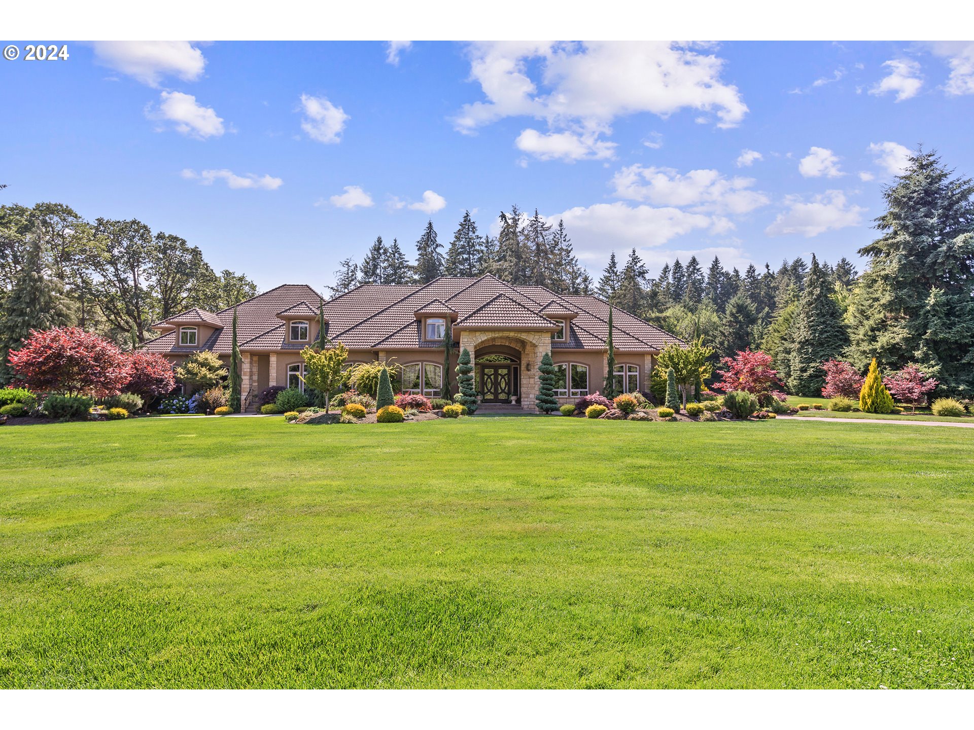 a front view of a house with a garden