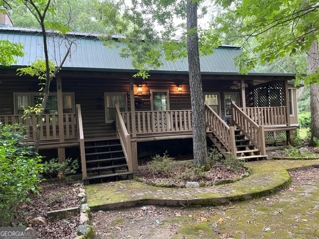 a front view of house yard with deck and wooden fence