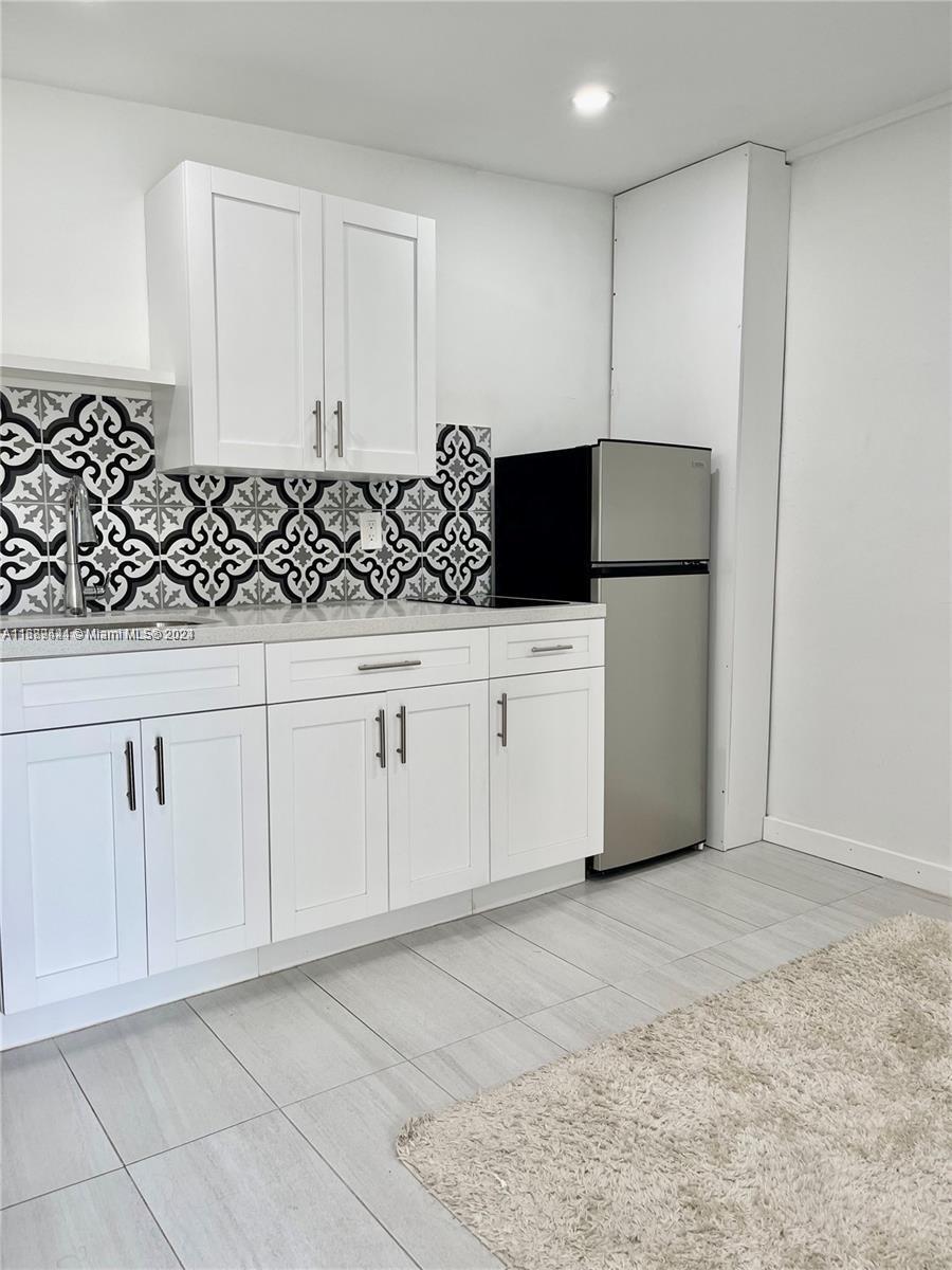 a kitchen with white cabinets