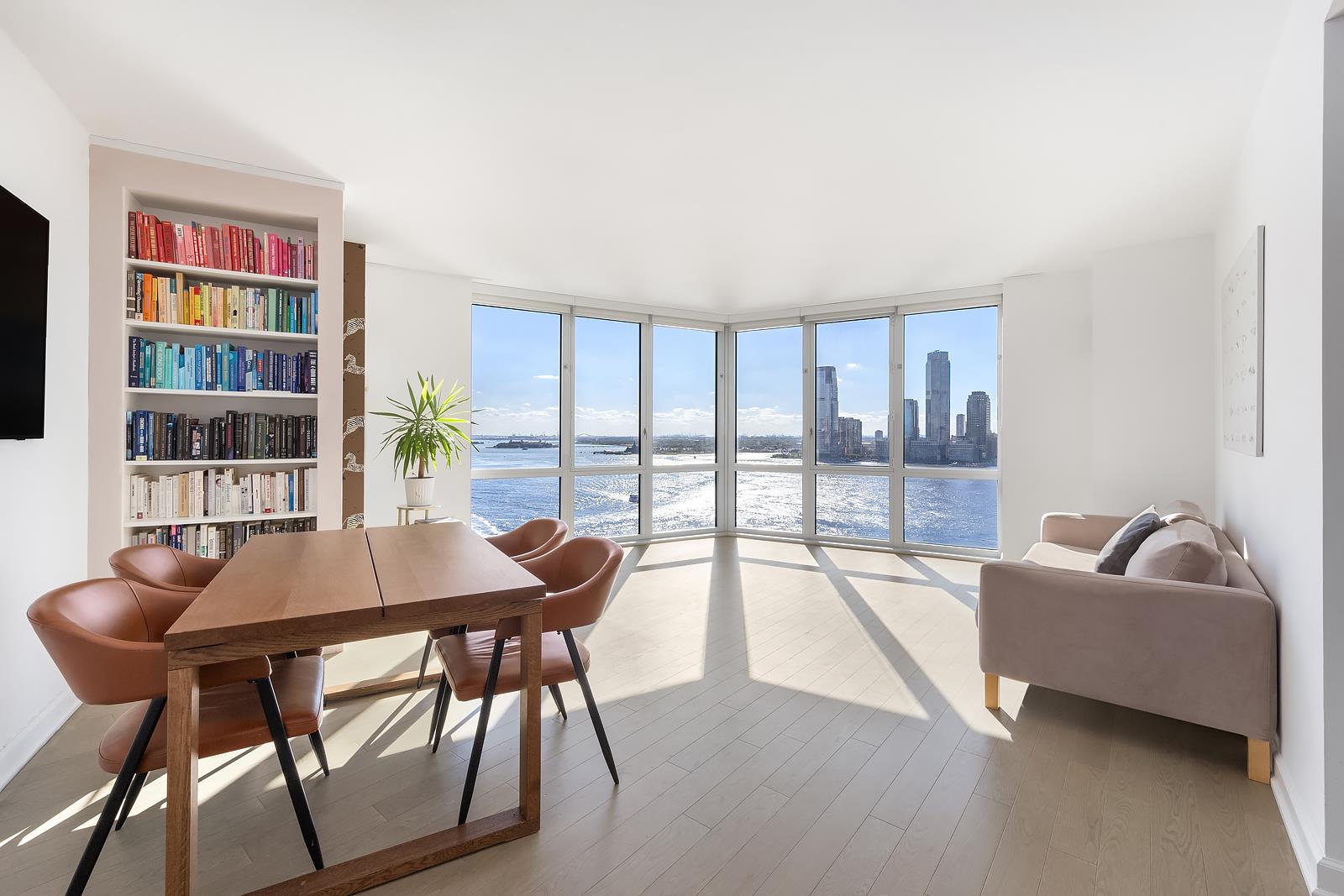 a dining room with furniture and a floor to ceiling window