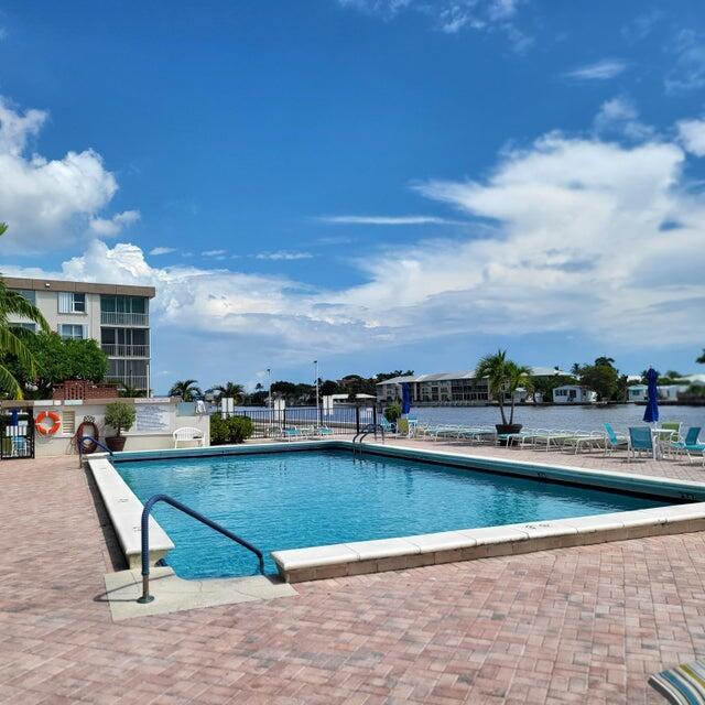 a view of a swimming pool with a lounge chair