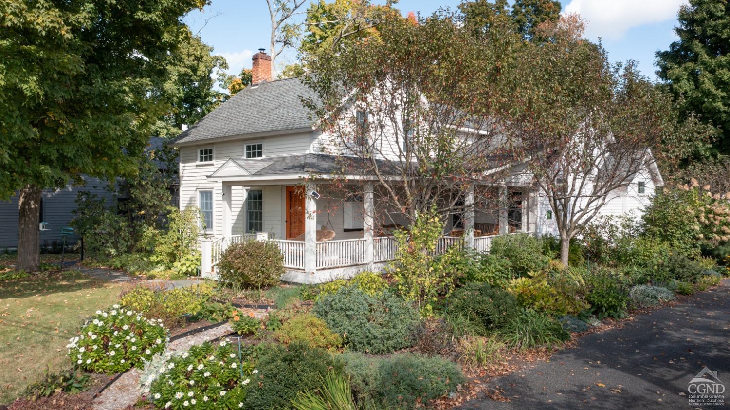 a front view of house with yard and trees around