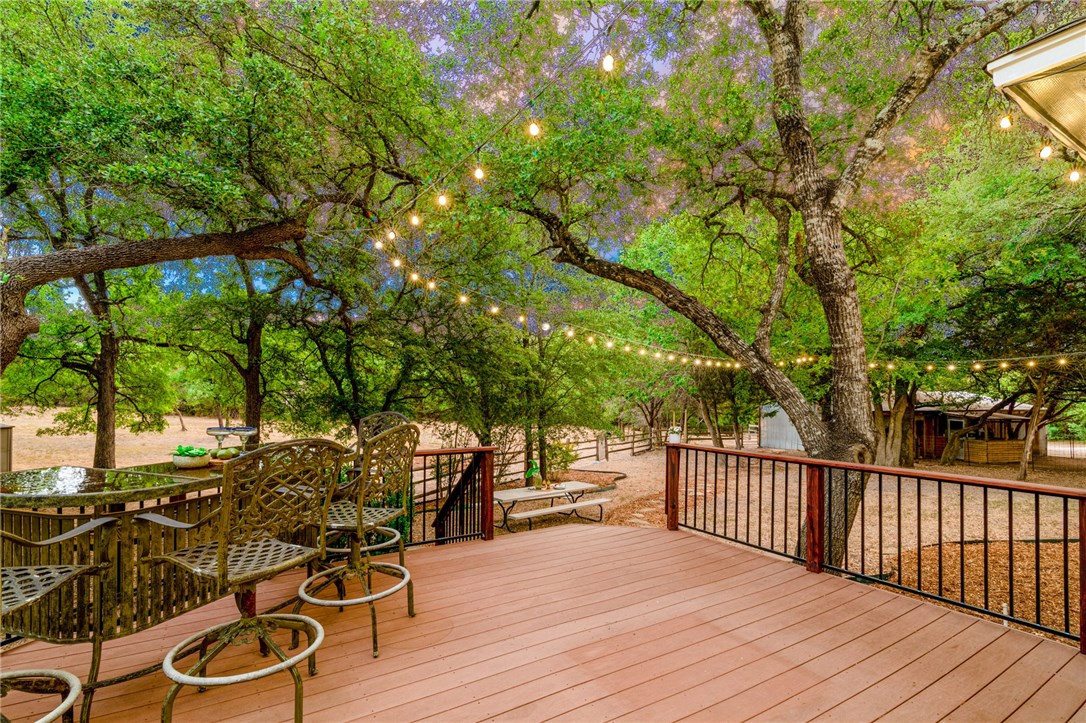 a view of a patio with table and chairs and wooden floor