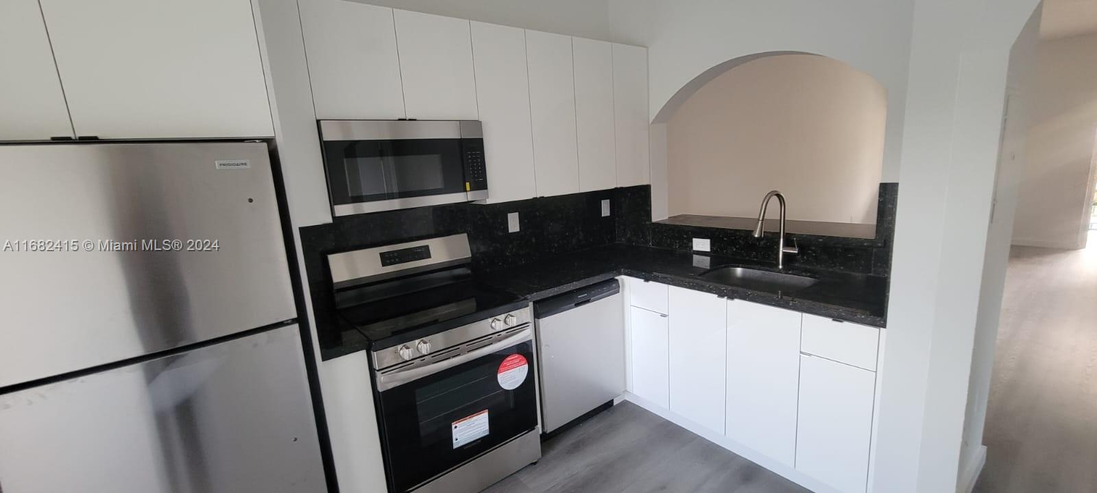 a kitchen with a refrigerator stove and microwave