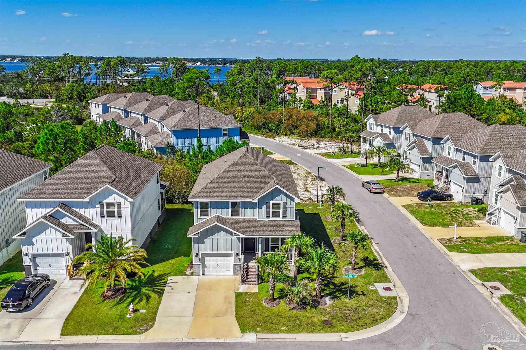 an aerial view of residential houses with outdoor space and swimming pool