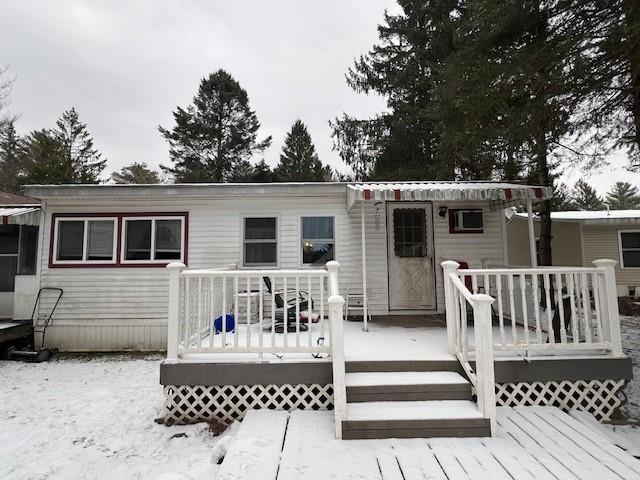 a view of a house with wooden deck