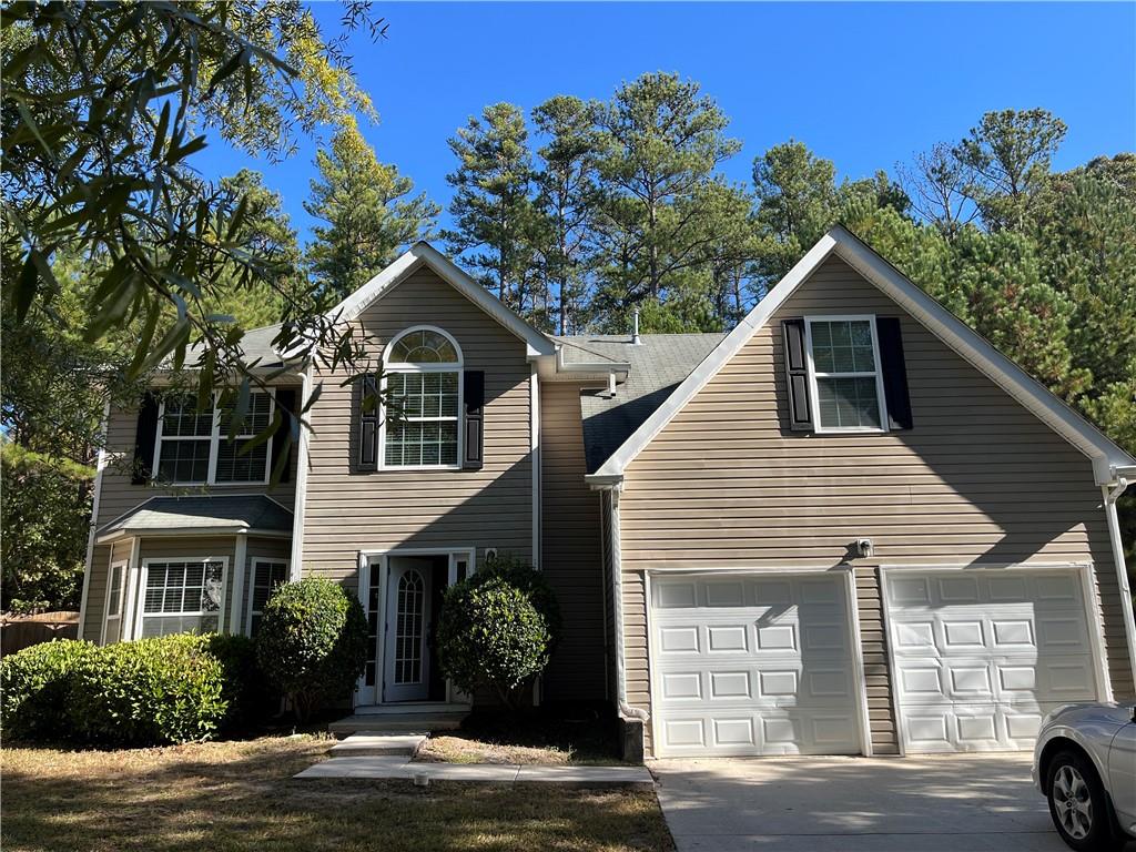 a view of a house with a tree in front of it