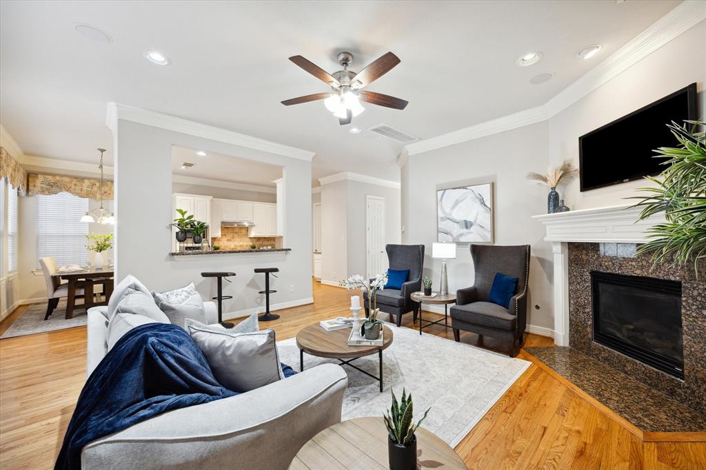 a living room with furniture a fireplace and a flat screen tv