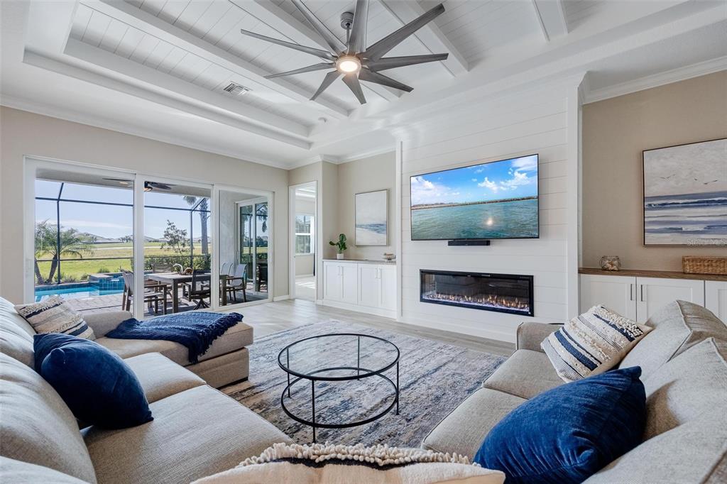 a living room with furniture flat screen tv and a fireplace