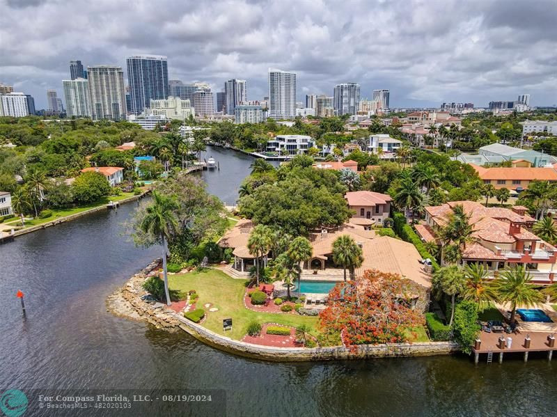 an aerial view of residential houses with outdoor space and lake view