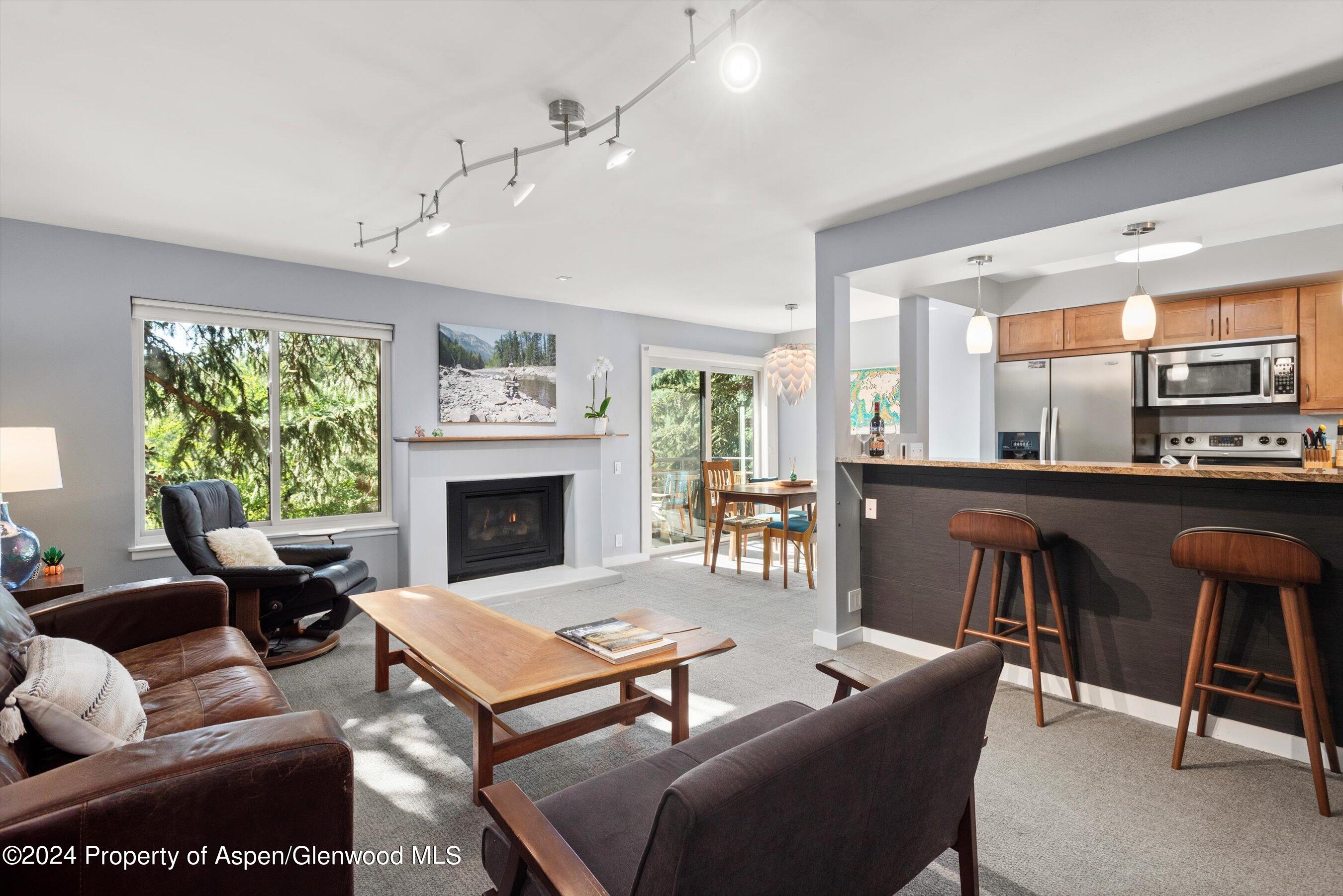 a living room with furniture a fireplace and a table