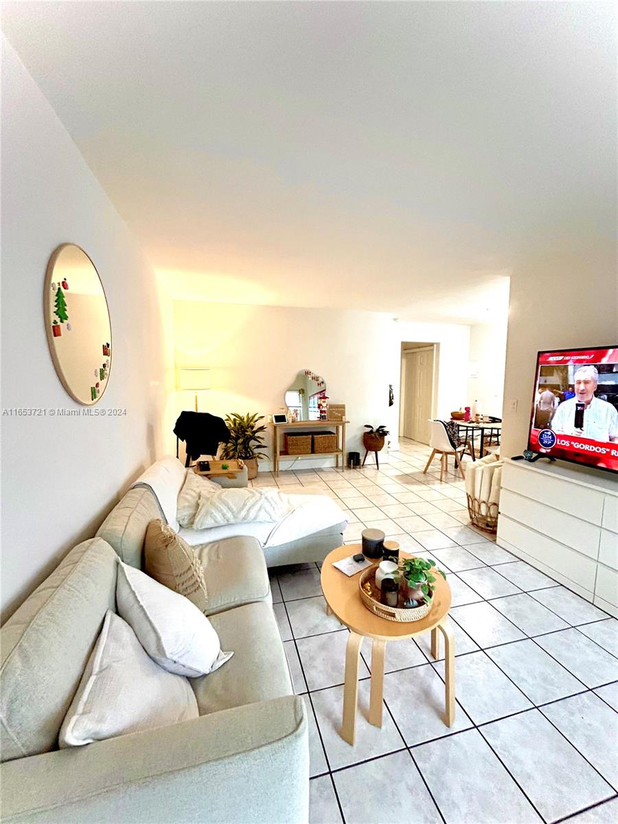 a living room with furniture a table and chairs