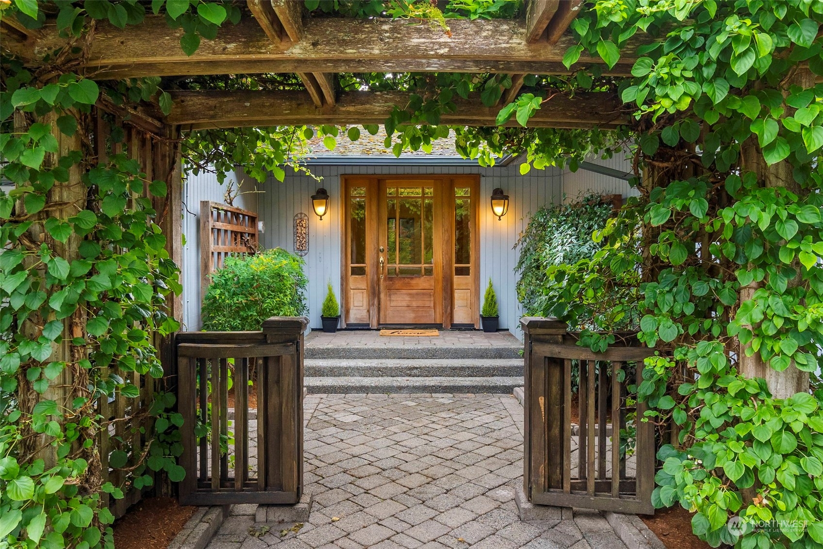 a front view of a house with plants