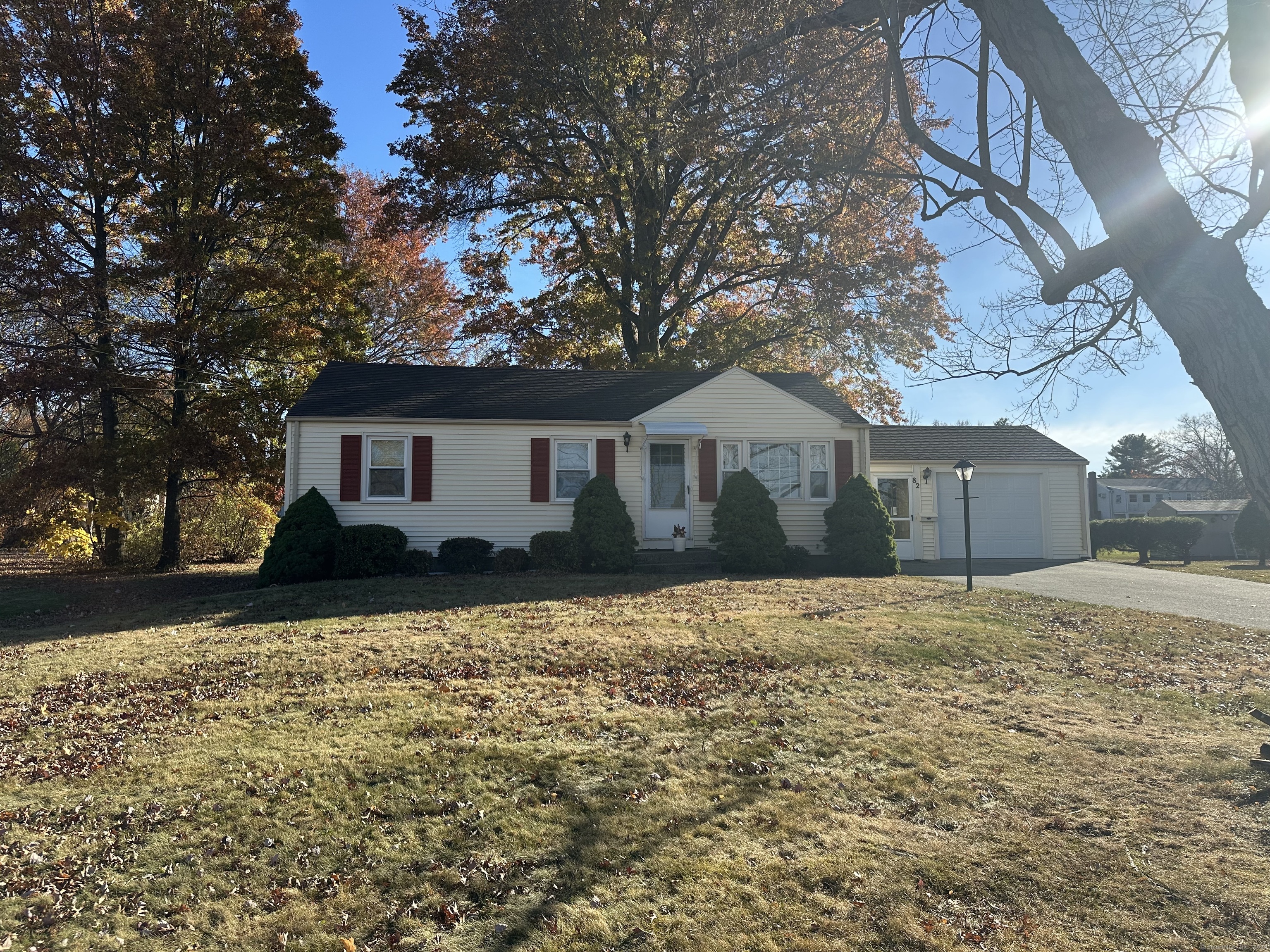 a front view of house with yard and trees