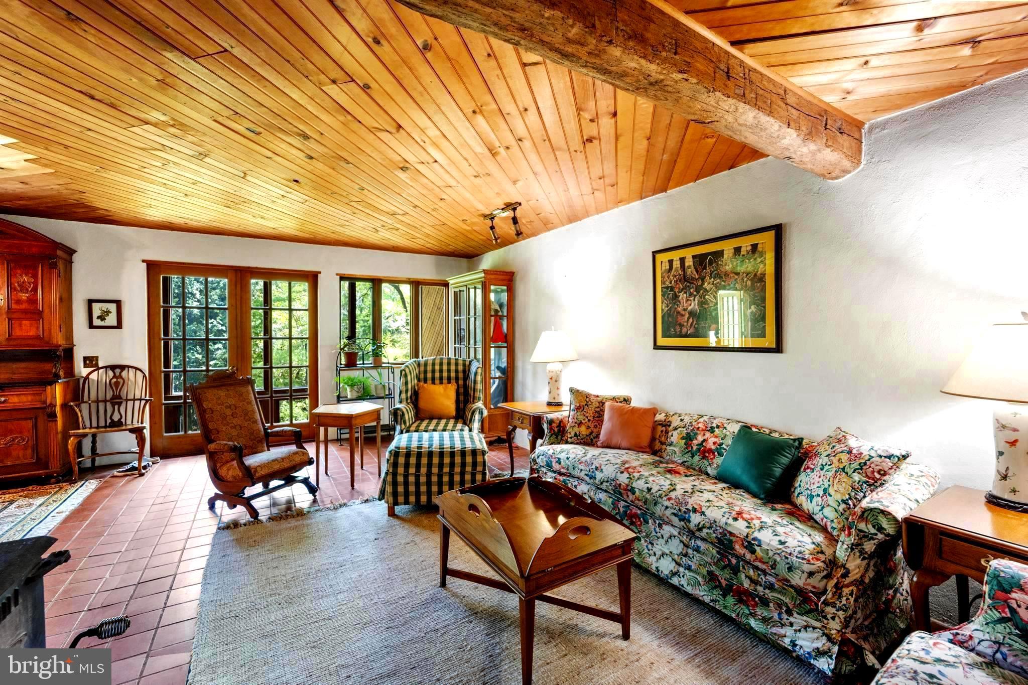 a living room with furniture and floor to ceiling window