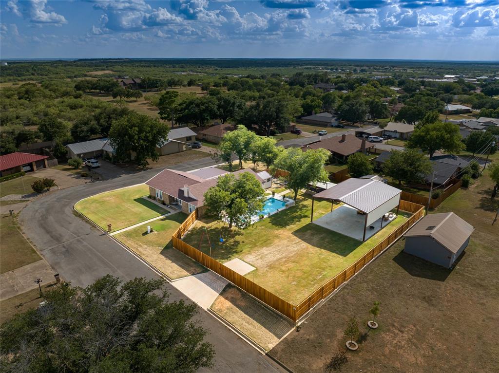 an aerial view of a house with a swimming pool