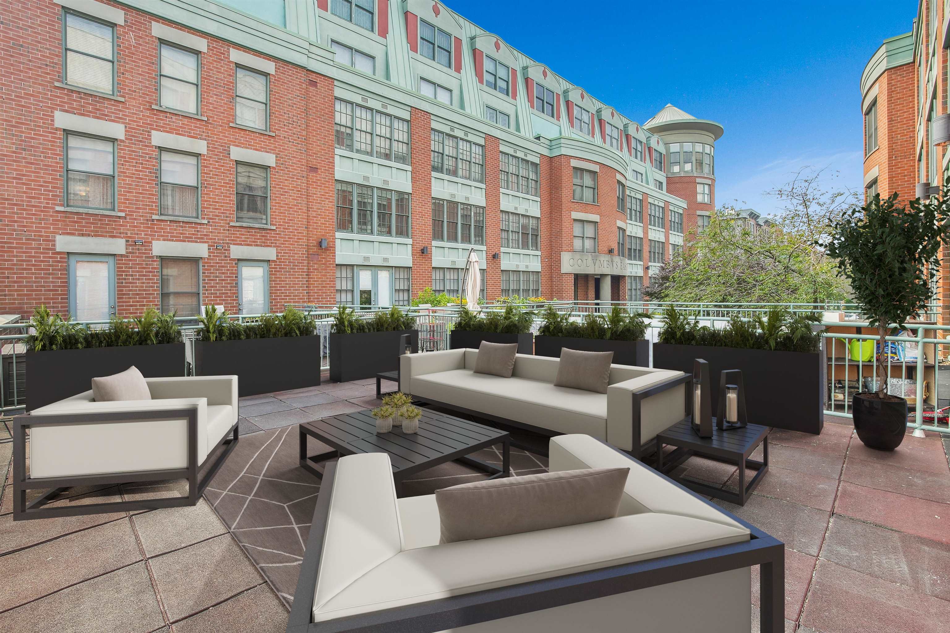 a view of a patio with couches and potted plants