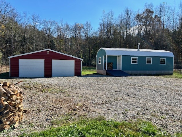 a front view of house with yard and trees in the background