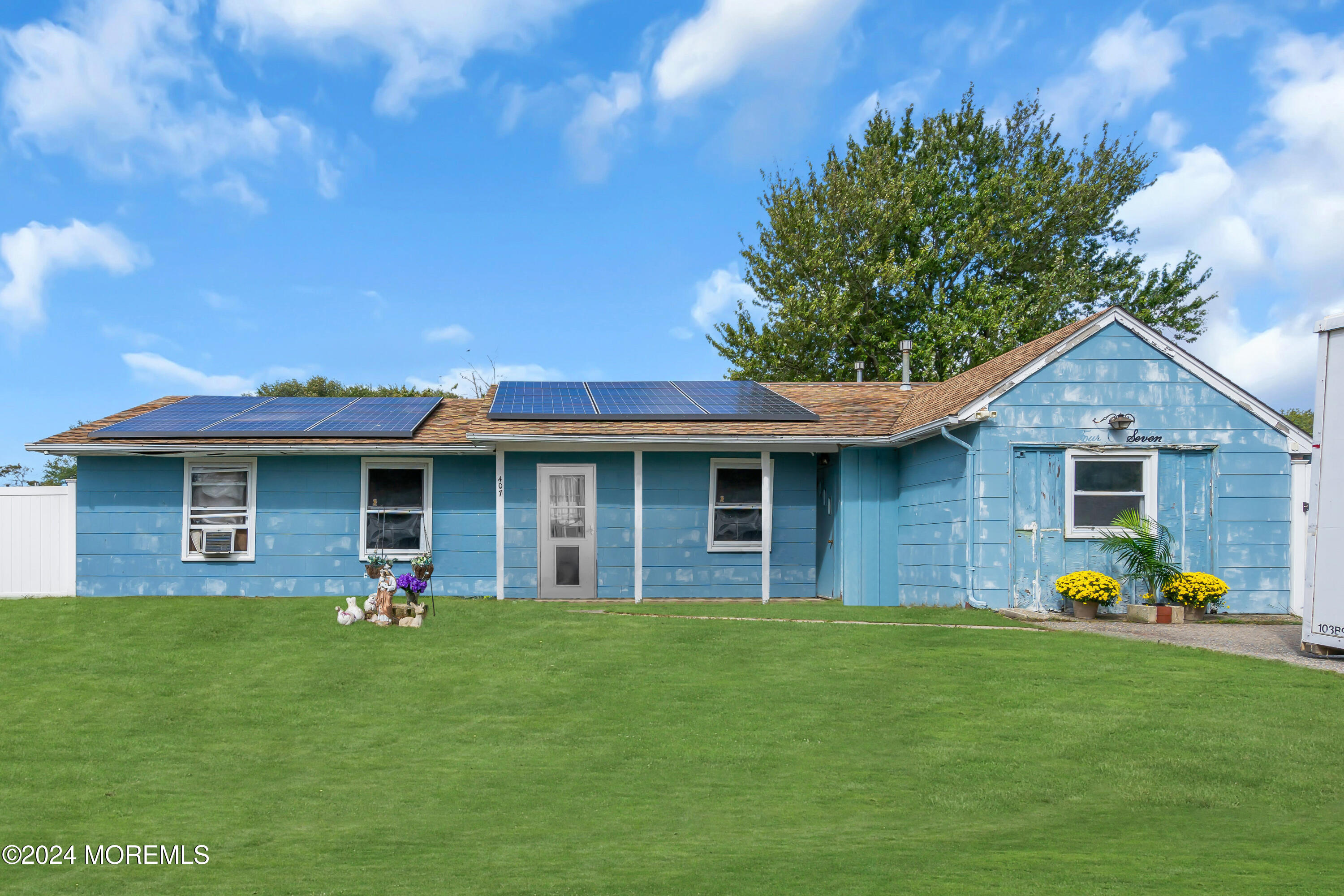 a front view of house with yard and outdoor seating