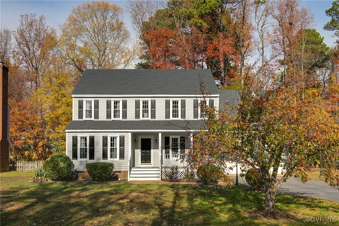 Colonial inspired home featuring a porch and a fro