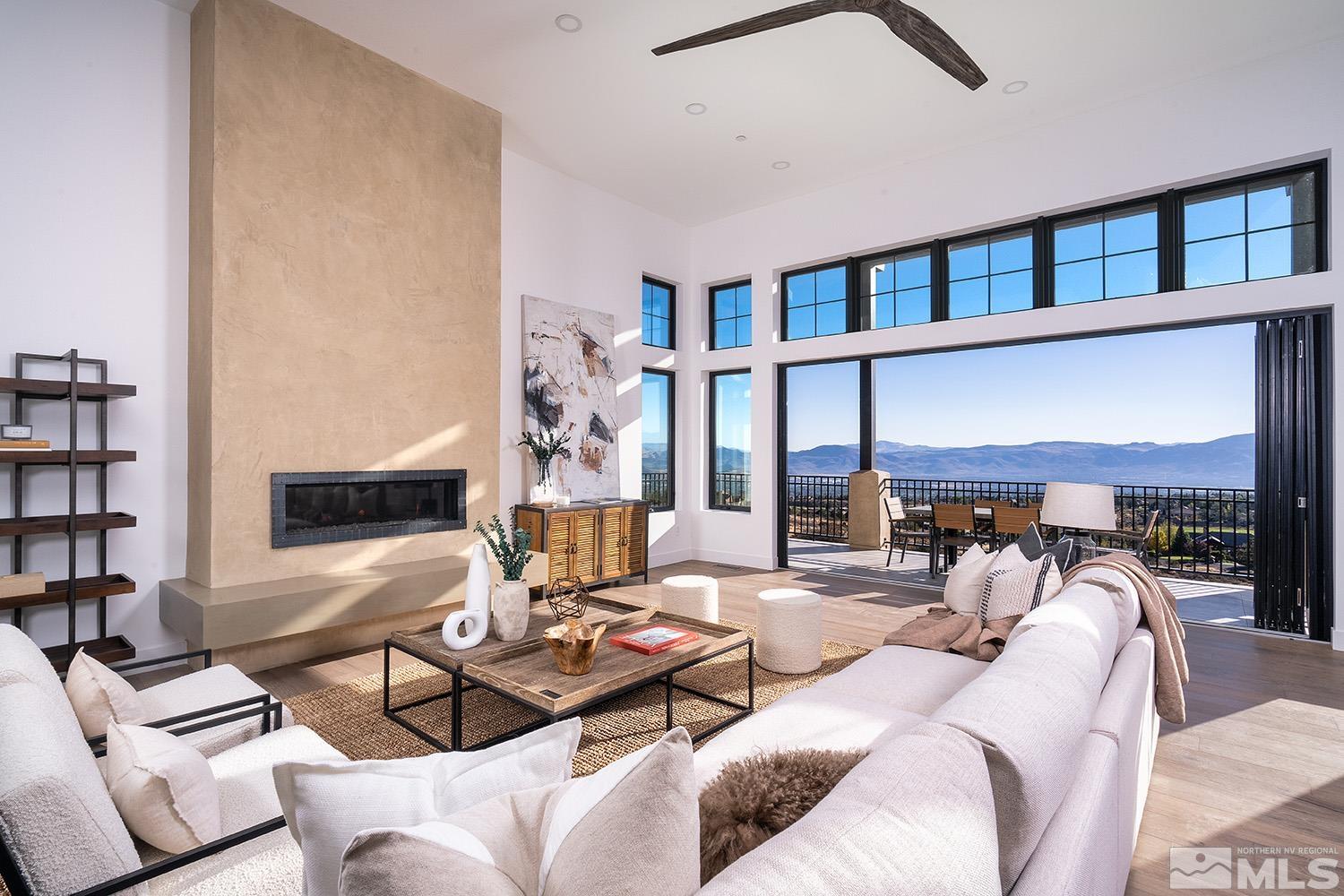 a living room with furniture and a floor to ceiling window