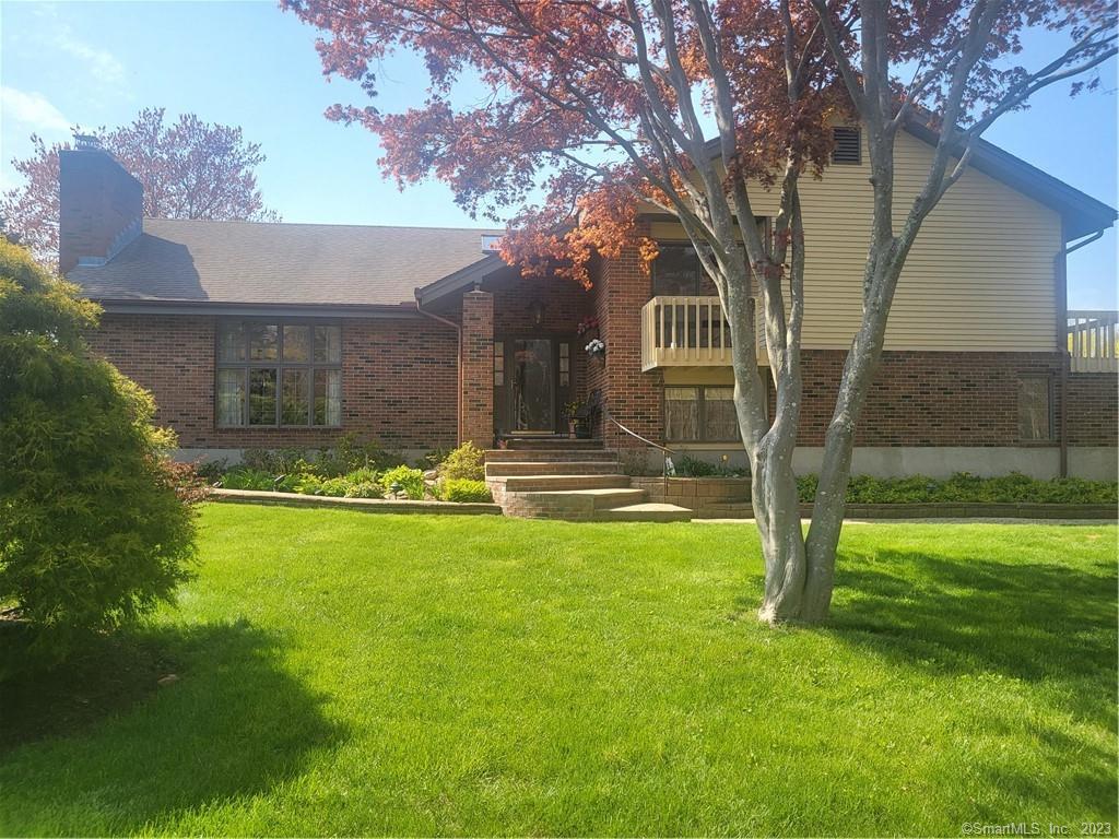 a front view of house with yard and swimming pool