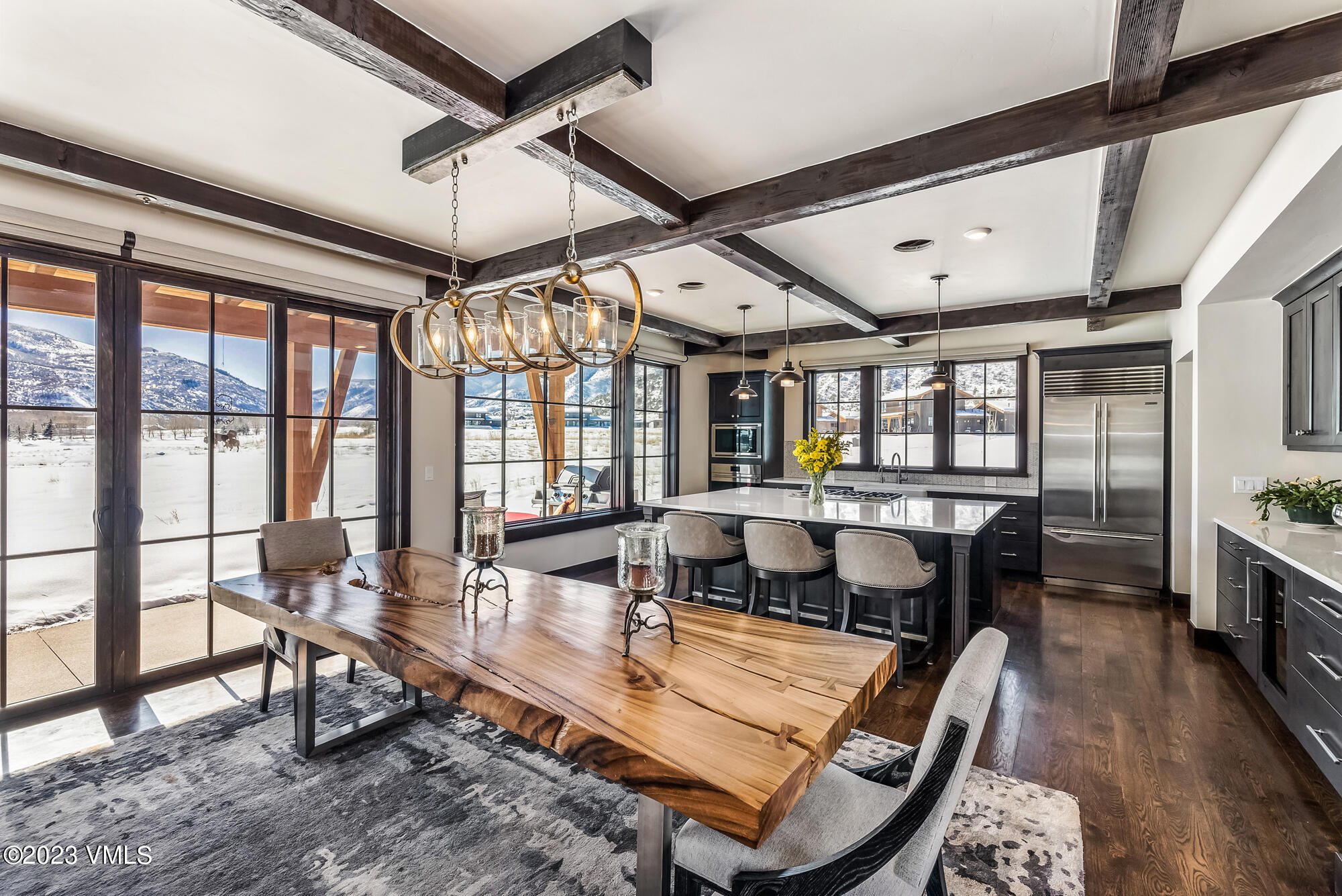 a living room with furniture a wooden floor and ceiling window