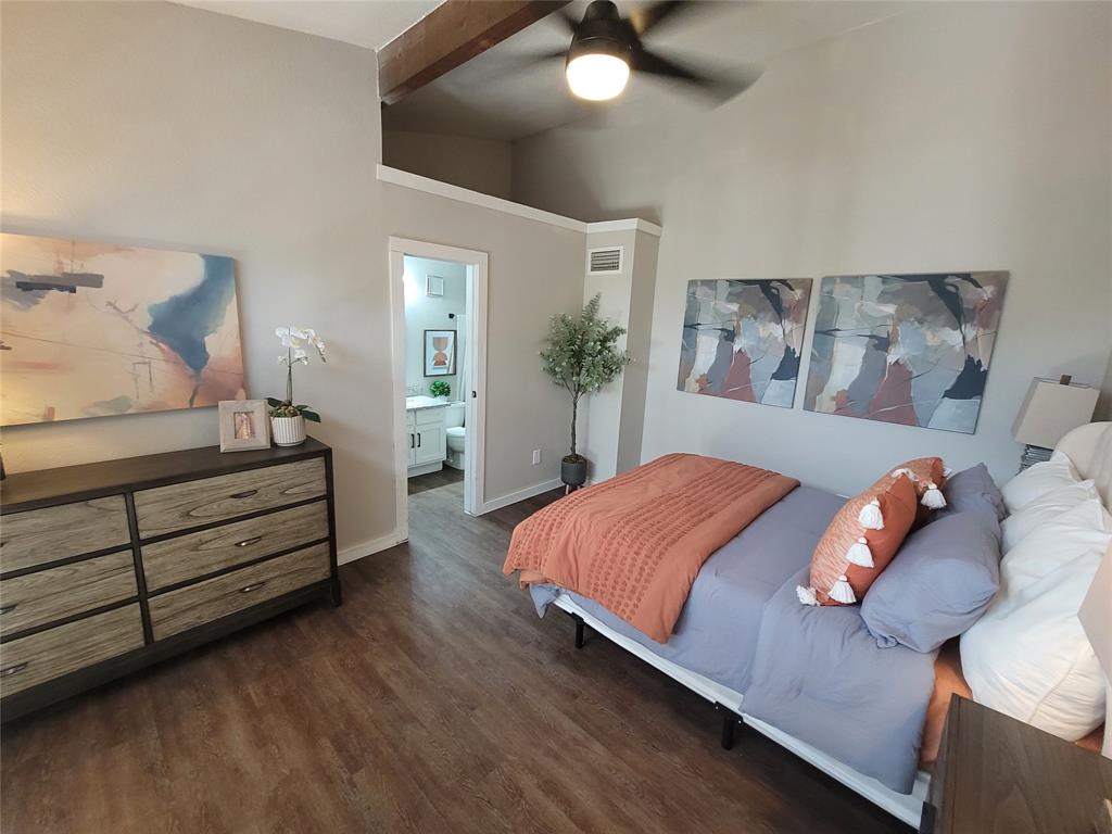 a bedroom with bed and a chandelier