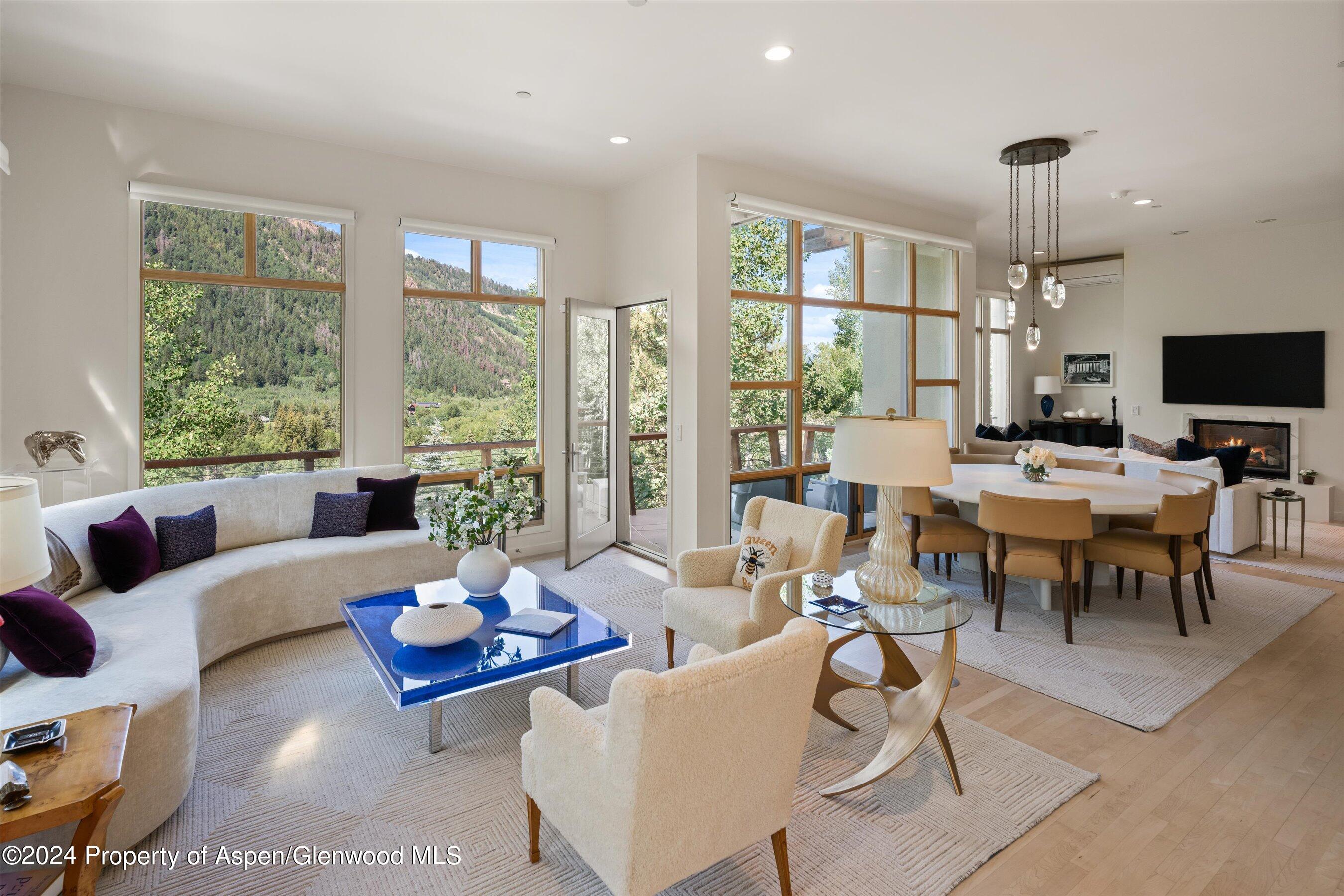 a living room with furniture large window and a table