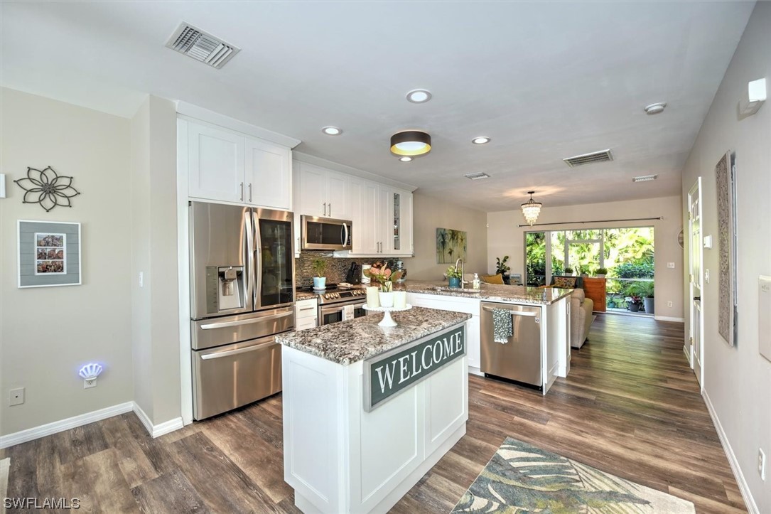 a kitchen with refrigerator and cabinets